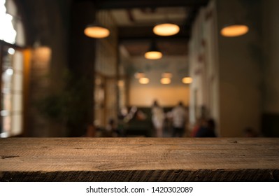 Image Of Wooden Table In Front Of Abstract Blurred Background Of Resturant Lights