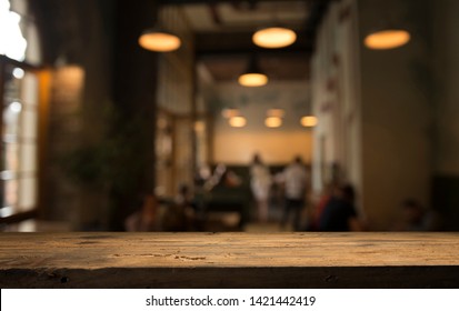 Image Of Wooden Table In Front Of Abstract Blurred Background Of Resturant Lights