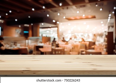 Image Of Wooden Table In Front Of Abstract Blurred Background Of Resturant