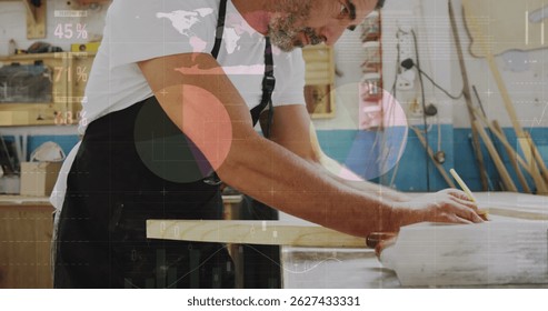 Image of world map and data processing over caucasian male carpenter working in workshop. Global communication, work and digital interface concept digitally generated image.