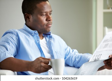 Image Of Young African Man Reading News In The Morning
