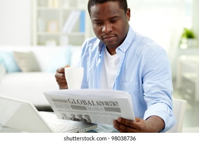 Image Of Young African Man Reading News In The Morning