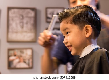 image of young asia boy at barber shop .