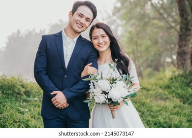 Image of young Asian bride and groom