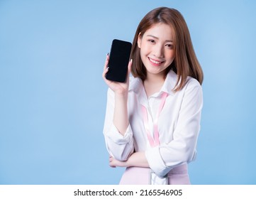 Image of young Asian businesswoman on blue background