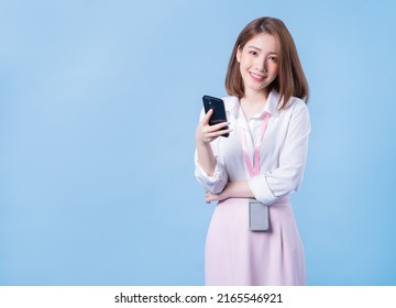 Image of young Asian businesswoman on blue background - Powered by Shutterstock