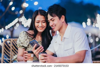 Image of young Asian couple dating at coffee shop - Powered by Shutterstock