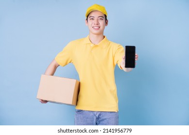 Image Of Young Asian Delivery Man On Blue Background