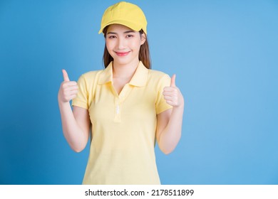 Image Of Young Asian Delivery Woman On Blue Background