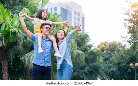 Image of young Asian family playing together at park - Shutterstock ID 2140574967