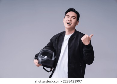 Image of young Asian man with helmet on background