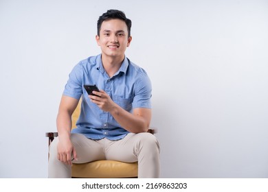 Image Of Young Asian Man Sitting On Chair