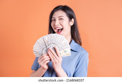 Image Of Young Asian Woman Holding Money On Background