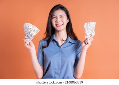 Image Of Young Asian Woman Holding Money On Background