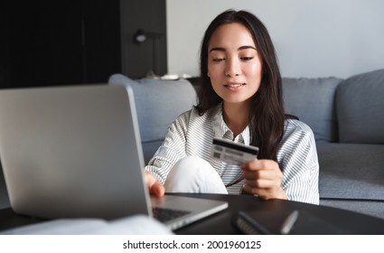 Image Of Young Asian Woman Order Online, Shopping From Home. Girl Enter Credit Card Info On Webside To Make Purchase, Using Laptop To Shop, Paying Bills With Computer