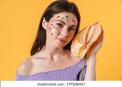 Image Of Young Beautiful Woman With Stickers On Face Holding Exotic Flower Isolated Over Yellow Background