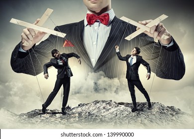 Image of young businessman puppeteer. Leadership concept