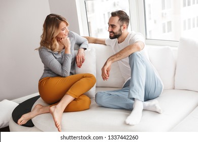 Image of young cute loving couple indoors at home talking with each other. - Shutterstock ID 1337442260