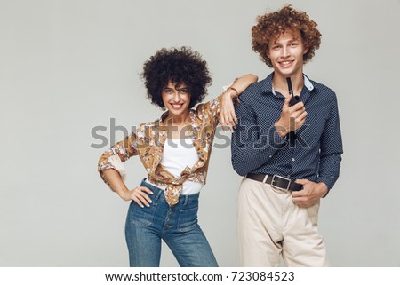Image of young emotional happy retro loving couple standing and posing isolated. Looking camera.