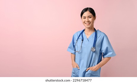 Image of young female doctor smiling and standing on the pink isolated background. - Powered by Shutterstock