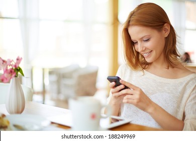 Image Of Young Female Reading Sms On The Phone In Cafe