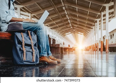 Image of Young freelance working at train station before travel. work and travel concept.
