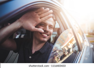 Image Of Young Handsome Guy Sitting In Car And Meet Someone.