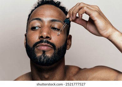 Image of a young man taking care of his skin. Beauty studio shot about skin care and products for the personal hygiene.