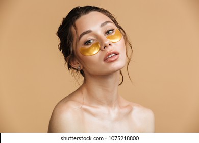 Image Of Young Pure Beautiful Gentle Woman Standing Naked Isolated Looking Camera Take Care Of Her Skin With Under Eye Patches.