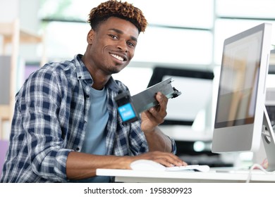 image of young student looking at camera at workplace