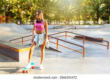 Image Of Young Stylish Woman Skater With Cruiser Board On Skate Park