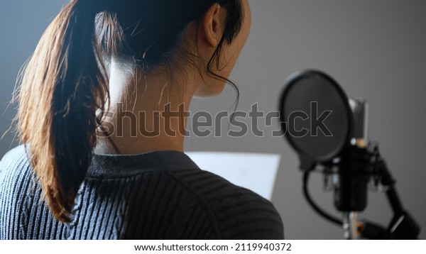 Image of a\
young voice actor doing post\
recording.