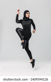 Image Of Young Woman Fitness Muslim Posing Running Jumping Isolated Over White Wall Background.