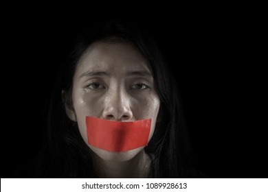 Image of young woman looks cried with her mouth covered by adhesive tape  - Powered by Shutterstock