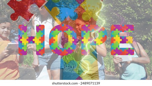 Images of colorful puzzle pieces and hope text over diverse group of children. Autism awareness concept digital generated image. - Powered by Shutterstock