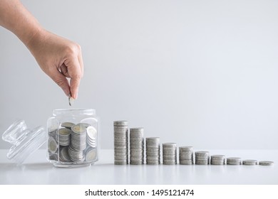 Images Of Growing Stacking Coins And Hand Putting Coin Into Glass Bottle (money Box) For Planning Step Up And Savings, Saving Money For Future Plan And Retirement Fund Concept.