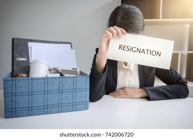 Images Of Packing Up All Her Personal Belongings And Files Into A Brown Cardboard Box And Business Woman Has Stress To Resignation In Modern Office, Resign Concept.