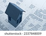 Imaginary cadastral map and General Urban Plan with buildings and land parcel - real estate property concept with cardboard house