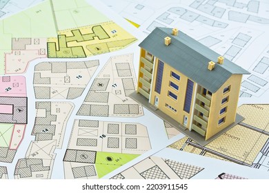 Imaginary cadastral map and general urban plan with cadastral parcels, urban destinations, vacant land plots and condominium residential building - Shutterstock ID 2203911545