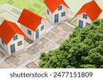 Imaginary cadastral map of territory with buildings and land parcel - Planning a new home and living in nature concept with home model and tree.