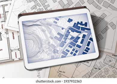 Imaginary cadastral map of territory with buildings and land parcel - concept image with a digital tablet - Note: the map background is totally invented and does not represent any real place. - Shutterstock ID 1937932363