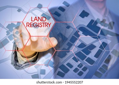 Imaginary cadastral map of territory with buildings, roads and land parcel - Land Registry concept with business manager pointing to icons against a digital display