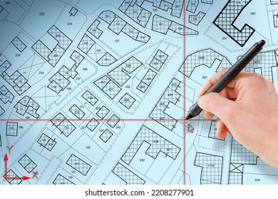 Imaginary cadastral map of territory with buildings and land plots drawn with a CAD (Computer-Aided-Design) computer software in dwg format file - concept with hand and digital pen - Shutterstock ID 2208277901