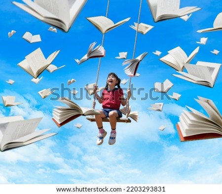 imagination concept, kid looking flying book