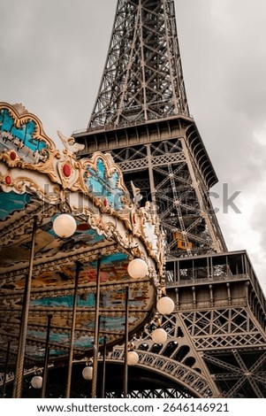 Imagine the iconic Eiffel Tower standing tall with a charming carousel or merrygoround situated right in front of it, creating a delightful scene