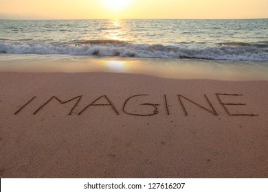 Imagine written in the sand on a sunset beach. - Powered by Shutterstock