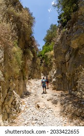 IMBROS GORGE, CRETE - 23 JULY 2021: Hikers exploring the narrow canyons and terrain of the Imbros Gorge in central Crete, Greece