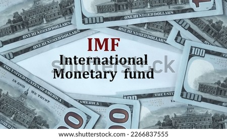 IMF (International Monetary Fund) - acronym on the background of cash dollar bills. Concept of economic growth and financial stability.