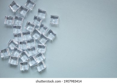 imitation artificial ice cubes plastic pieces transparent acrylic not really cold, optical illusion ready to eat on the table outdoor top view copy space for text food background