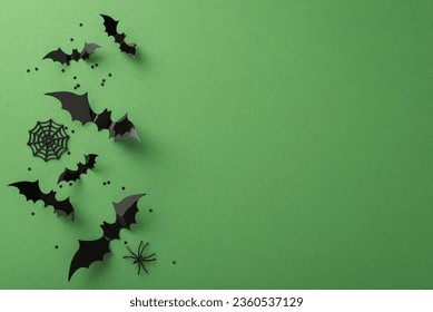 Immerse in a Halloween masterpiece! Top-down view of spooky decorations: ghastly spiders, cobweb, flying bats. Green background with confetti and an empty space for your message or promotion - Powered by Shutterstock